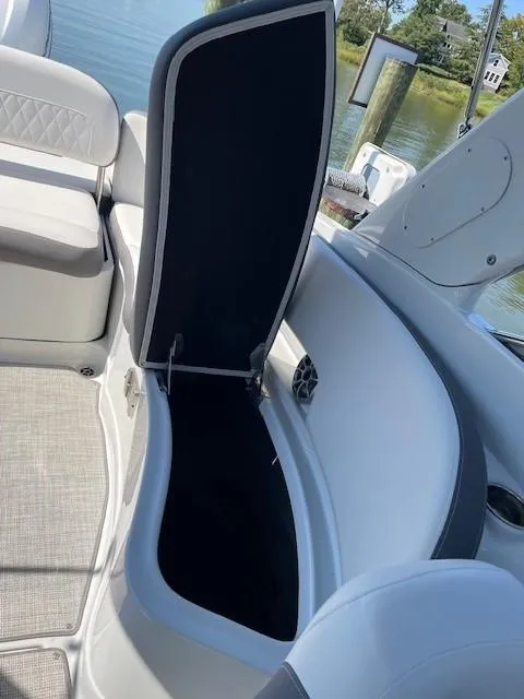 Slide: The Image of 2023 Crownline 290 XSS boat interior storage compartment open. - 22