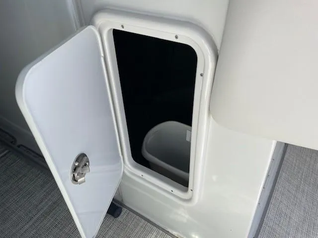 Slide: The Image of Open storage compartment on 2023 Crownline 290 XSS boat. - 24