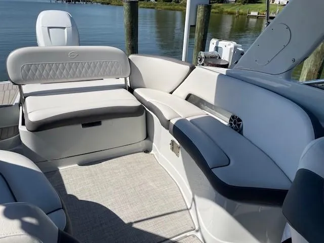 Slide: The Image of 2023 Crownline 290 XSS boat interior with elegant seating and waterfront view. - 29