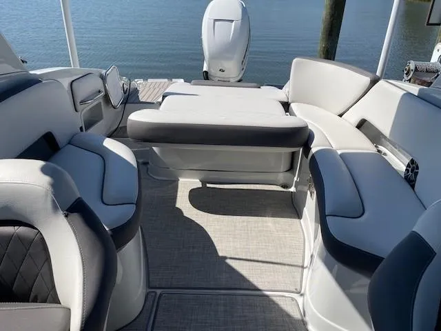 Slide: The Image of 2023 Crownline 290 XSS boat interior with plush seating and modern design. - 30