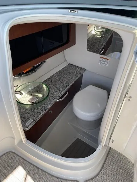 Slide: The Image of 2023 Crownline 290 XSS boat bathroom with modern sink and toilet. - 31