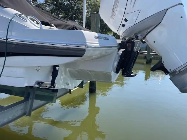 Slide: The Image of 2023 Crownline 290 XSS boat with outboard motor on water. - 5