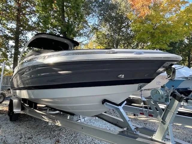 Slide: The Image of 2023 Crownline 290 XSS boat on trailer, surrounded by autumn trees. - 9