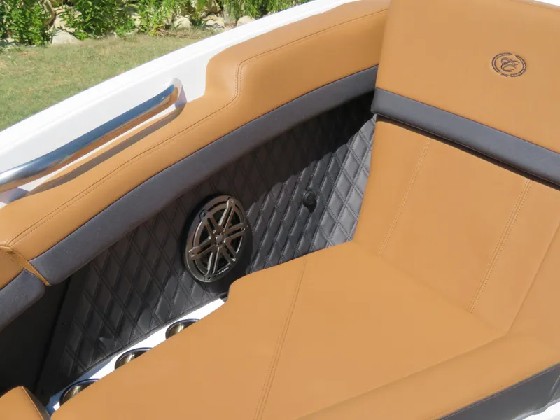 Slide: The Image of 2024 Cobalt R4 boat interior with tan leather seats and speaker detail. - 12