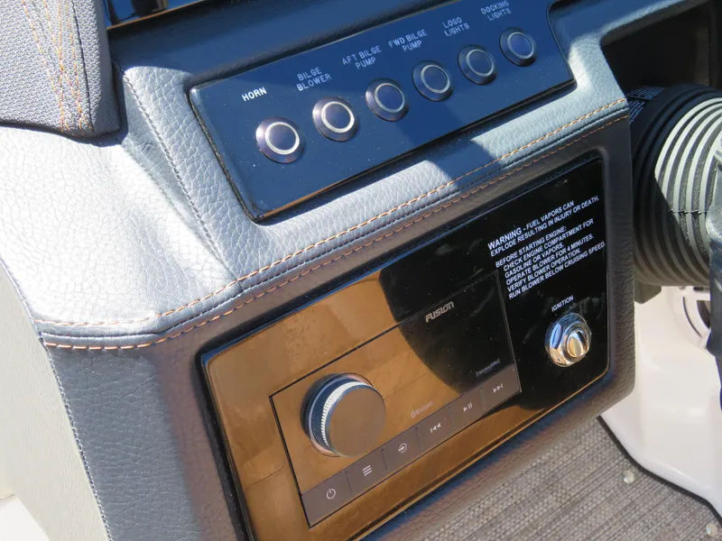 Slide: The Image of 2024 Cobalt R4 boat dashboard with control buttons and audio system. - 17