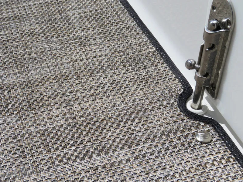 Slide: The Image of Close-up of 2024 Cobalt R4 boat's textured flooring and metal hinge detail. - 18