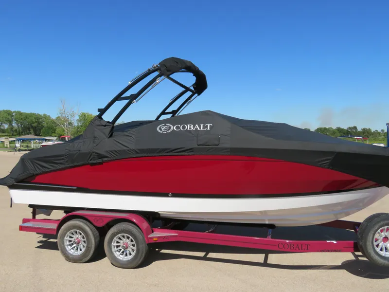 Slide: The Image of 2024 Cobalt R4 boat on trailer, covered, red and black design. - 19