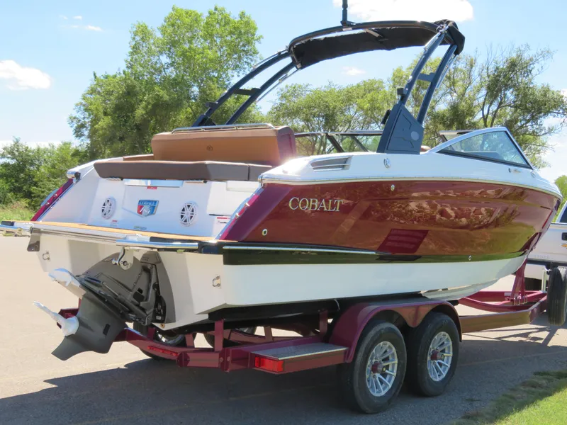 Slide: The Image of 2024 Cobalt R4 boat on trailer, red and white design, parked outdoors. - 2