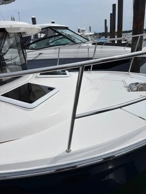 Slide: The Image of 2023 Ranger Tugs R-29 S boat docked at marina, showcasing sleek design and windows. - 10