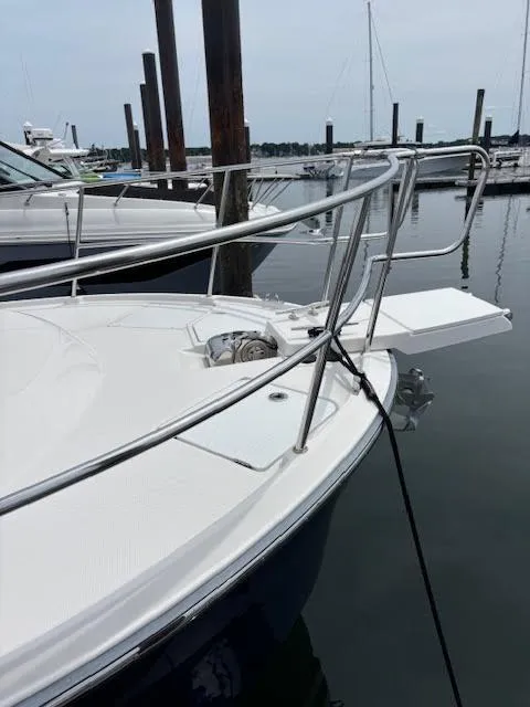 Slide: The Image of 2023 Ranger Tugs R-29 S boat docked at marina, featuring sleek bow design. - 11