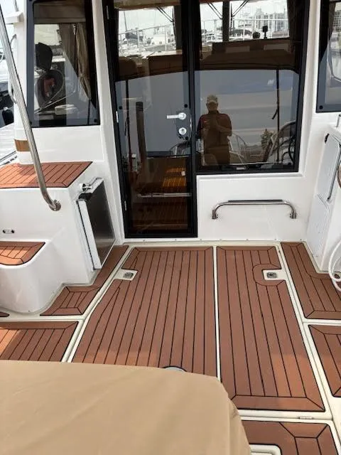 Slide: The Image of 2023 Ranger Tugs R-29 S boat interior with teak flooring and modern design. - 13