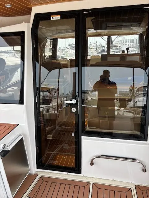 Slide: The Image of 2023 Ranger Tugs R-29 S boat with glass door and wooden deck. - 19