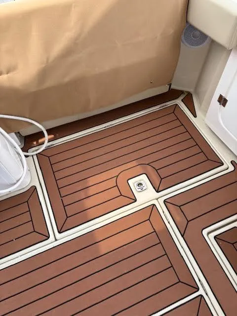 Slide: The Image of 2023 Ranger Tugs R-29 S boat deck with brown and white patterned flooring. - 23