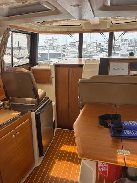 Slide: The Image of Interior of 2023 Ranger Tugs R-29 S boat, featuring wood finishes and modern amenities. - 30
