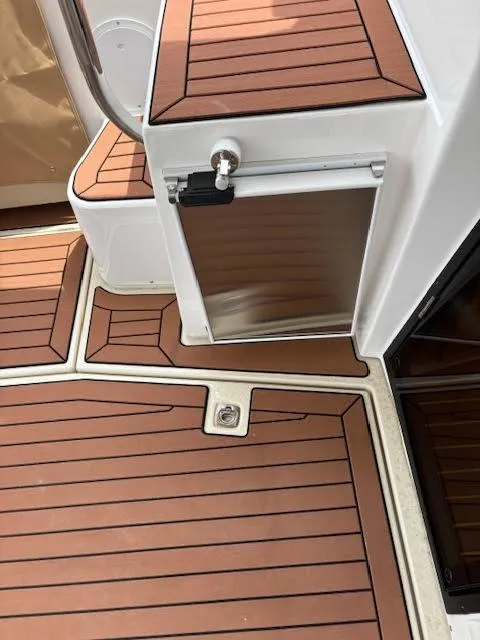 Slide: The Image of 2023 Ranger Tugs R-29 S boat deck with wood finish and storage compartment. - 7