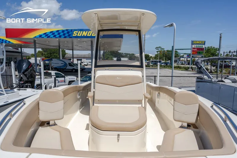 Slide: The Image of 2023 Scout 215 XSF boat at a dealership, showcasing seating and console. - 8
