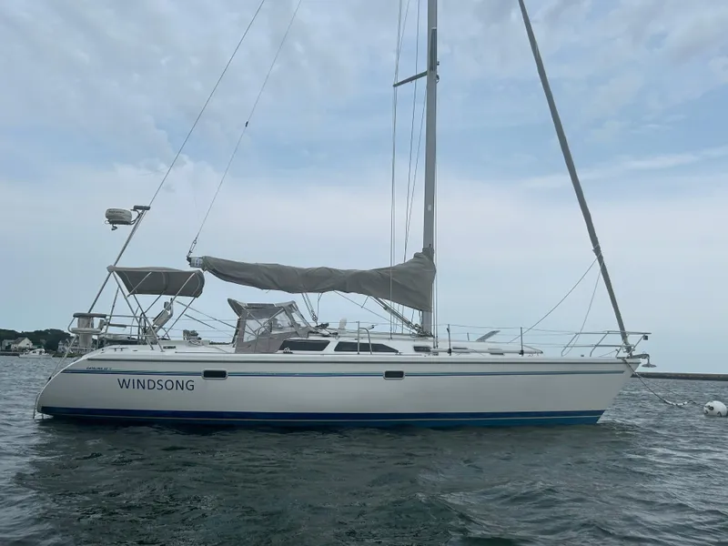 Slide: The Image of 1998 Catalina 42 MkII sailboat "Windsong" on calm water, side view. - 1