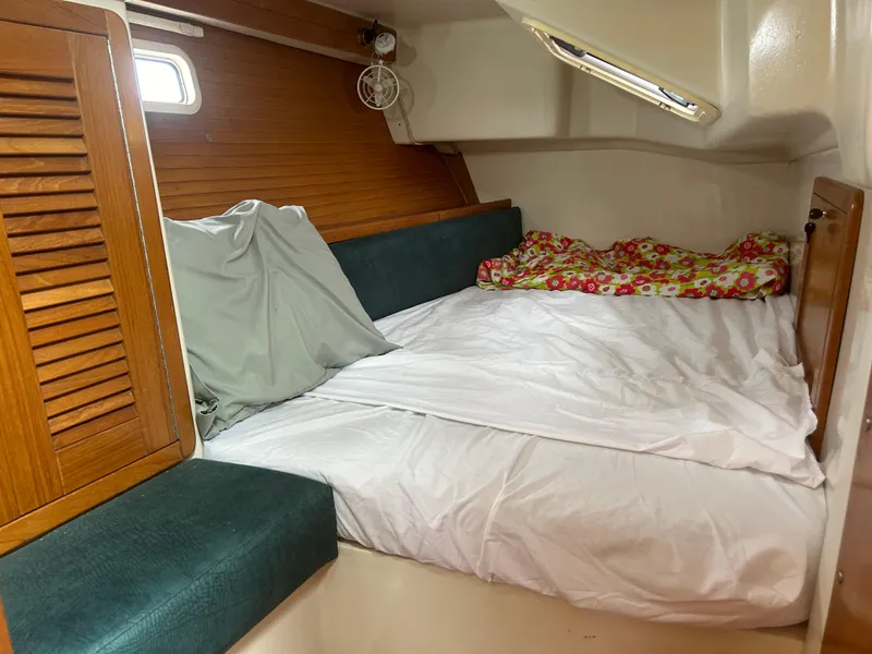 Slide: The Image of Cozy cabin interior of 1998 Catalina 42 MkII sailboat with bed and wooden accents. - 10