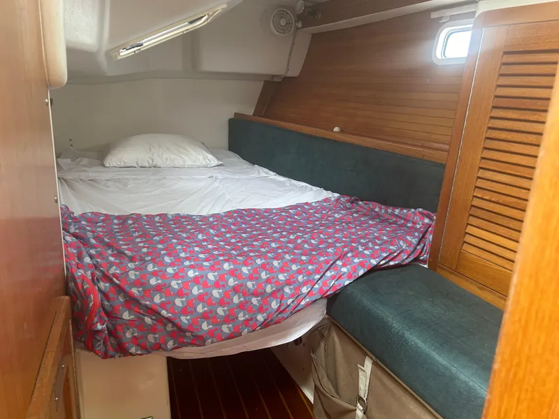 Slide: The Image of Cozy cabin interior of 1998 Catalina 42 MkII sailboat with bed and wooden accents. - 12