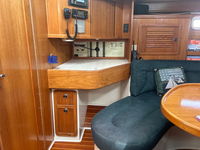 Slide: The Image of Interior of 1998 Catalina 42 MkII sailboat with wood paneling and navigation equipment. - 13