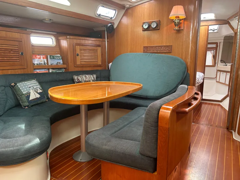 Slide: The Image of Interior of 1998 Catalina 42 MkII sailboat with cozy seating and wooden table. - 15