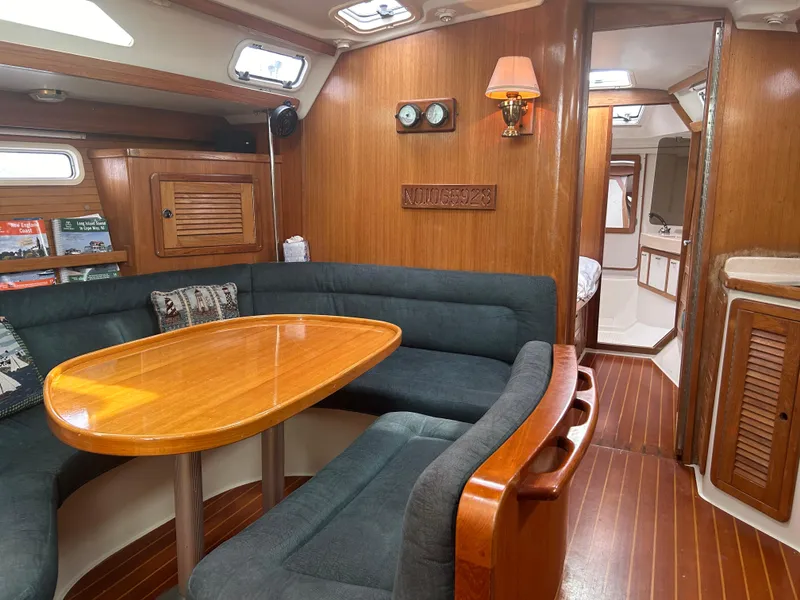 Slide: The Image of Interior of 1998 Catalina 42 MkII sailboat with wood finish and cozy seating area. - 16