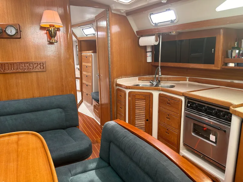 Slide: The Image of Interior of a 1998 Catalina 42 MkII sailboat with wood finish and cozy seating area. - 17