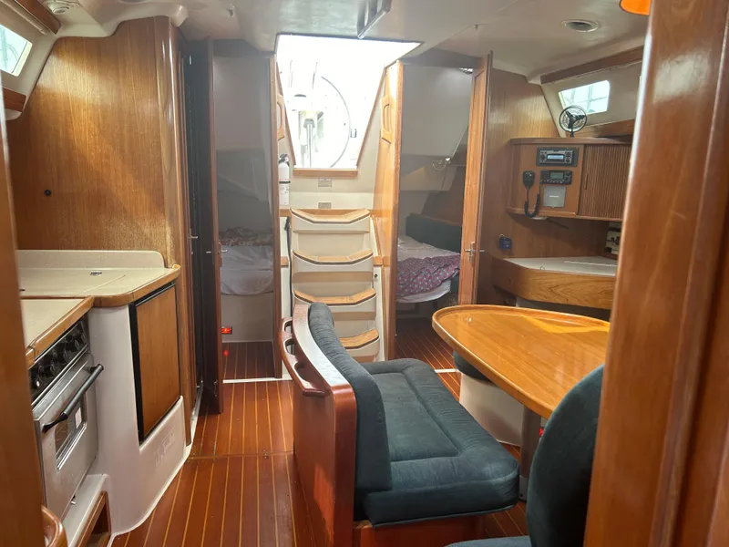 Slide: The Image of Interior of 1998 Catalina 42 MkII sailboat with wood finish and cozy seating area. - 19