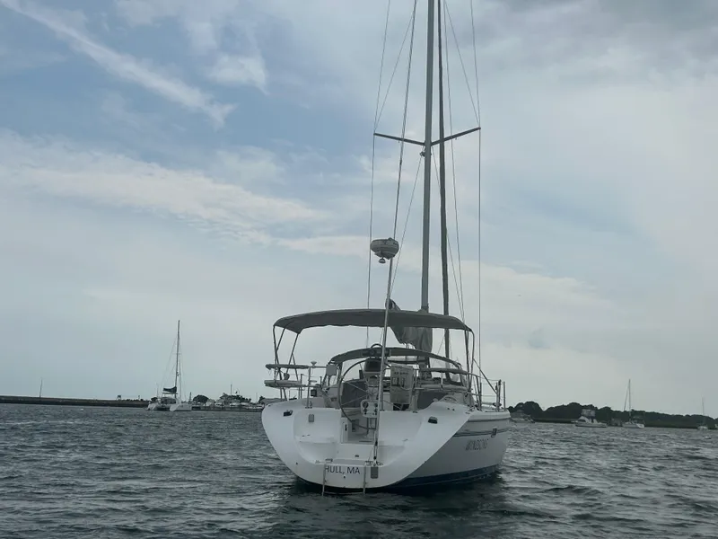 Slide: The Image of 1998 Catalina 42 MkII sailboat on calm waters under cloudy sky. - 2