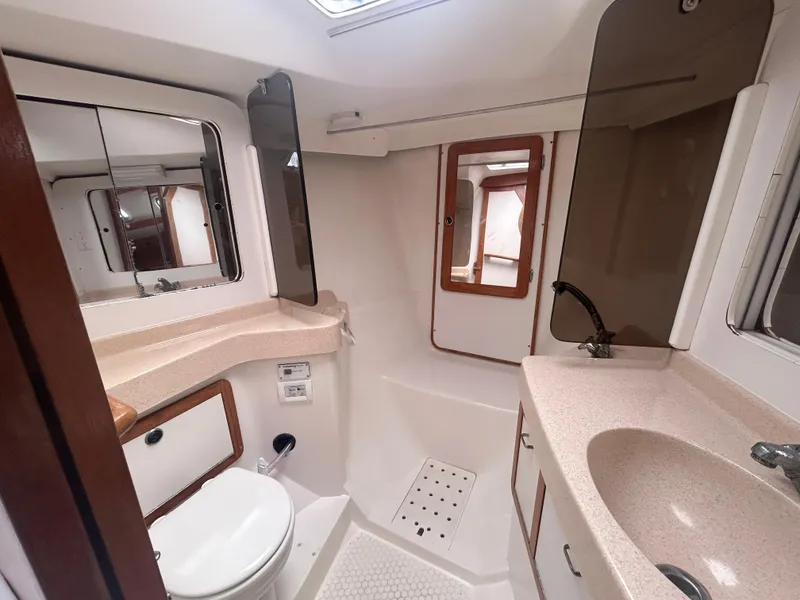 Slide: The Image of 1998 Catalina 42 MkII yacht bathroom with sink, toilet, and mirror. - 20