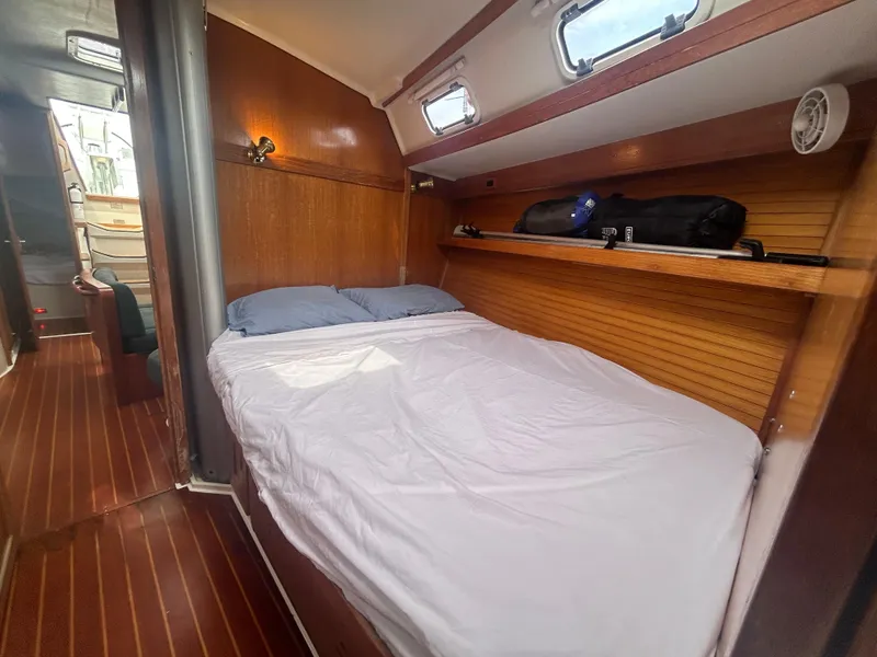 Slide: The Image of Cozy cabin interior of 1998 Catalina 42 MkII sailboat with wooden accents and bedding. - 21