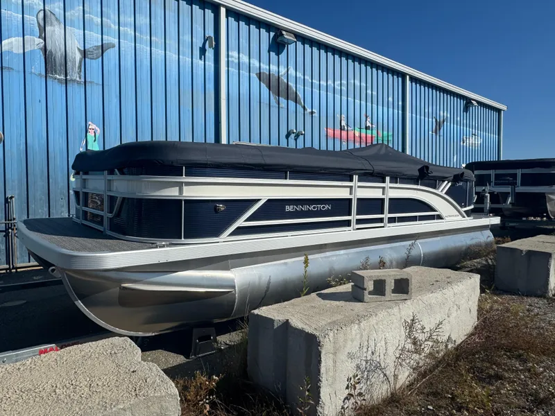 The Image of 2025 Bennington 22 SSRSR pontoon boat with cover, parked outdoors. - 0