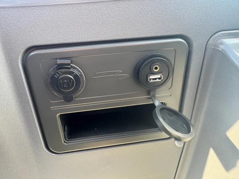 Slide: The Image of 2025 Bennington 22 SSRSR dashboard with 12V and USB charging ports. - 10