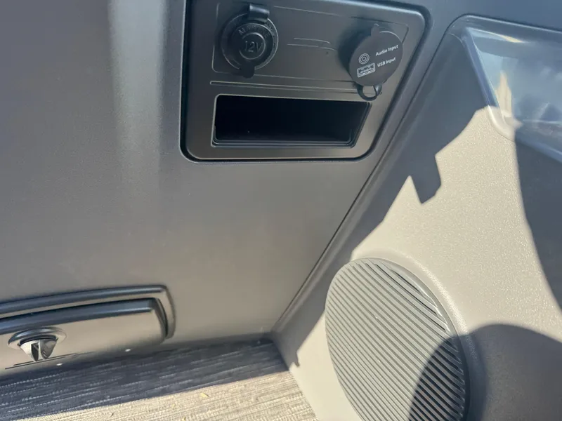 Slide: The Image of 2025 Bennington 22 SSRSR interior detail with power outlet and speaker. - 11