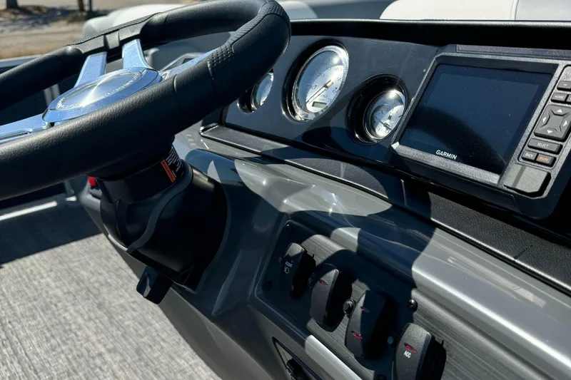 Slide: The Image of 2025 Bennington 22 SSRSR boat dashboard with steering wheel and navigation display. - 4