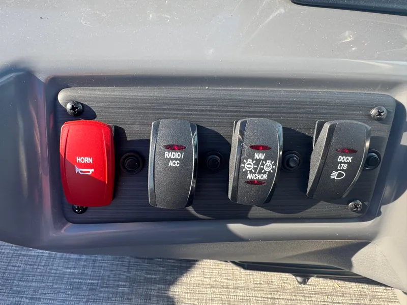 Slide: The Image of Control panel of 2025 Bennington 22 SSRSR boat with horn, radio, navigation, and dock lights switches. - 8