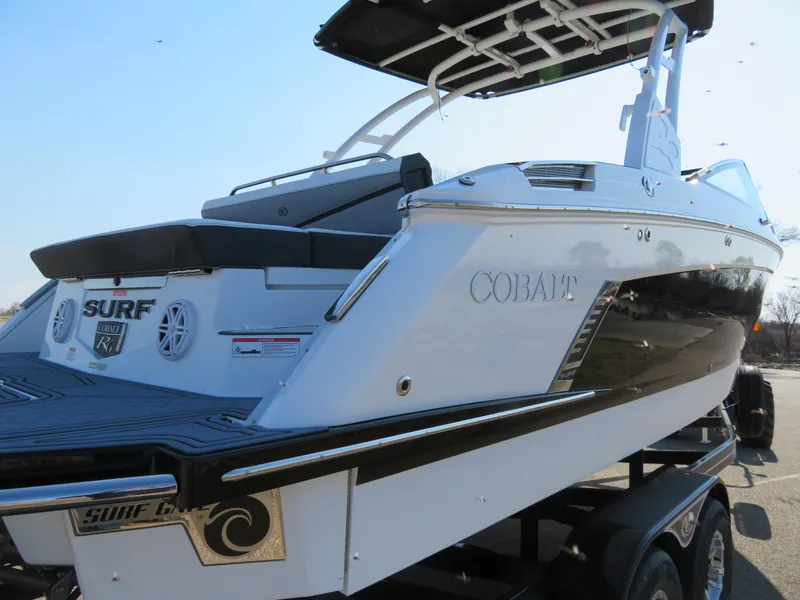 Slide: The Image of 2024 Cobalt R6 Surf boat, sleek design, black and white exterior, on trailer. - 12
