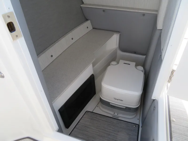 Slide: The Image of 2024 Cobalt R6 Surf boat interior with compact marine toilet. - 19