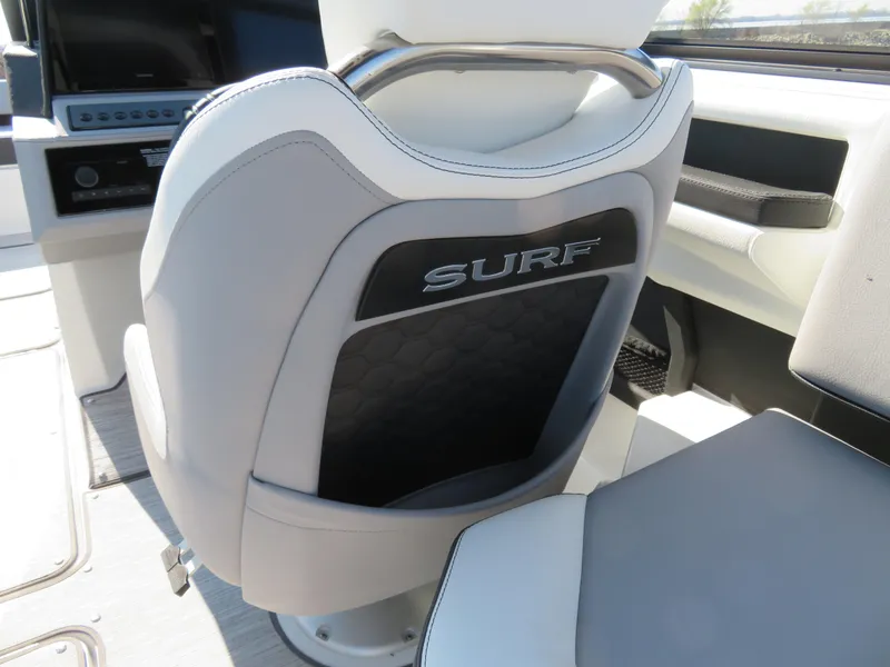 Slide: The Image of 2024 Cobalt R6 Surf boat interior with stylish seating and "Surf" branding. - 21