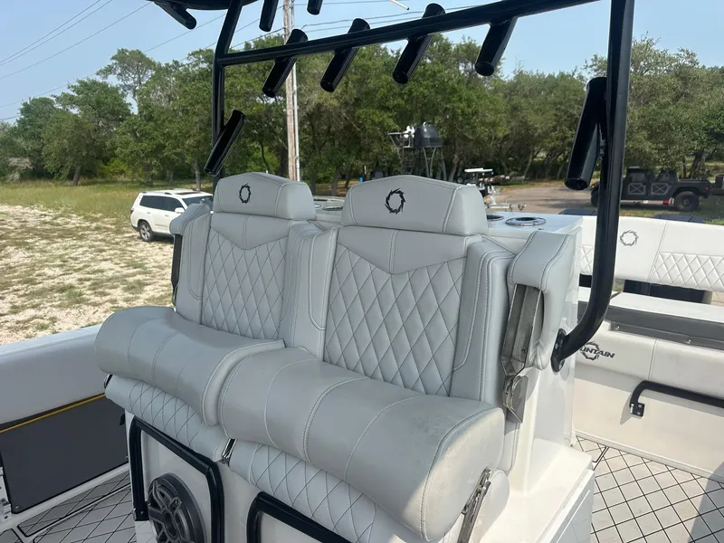 Slide: The Image of 2021 Fountain 34TE boat with luxurious white quilted seating and rod holders. - 12