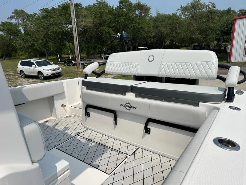 Slide: The Image of 2021 Fountain 34TE boat interior with white seating and storage compartments. - 14