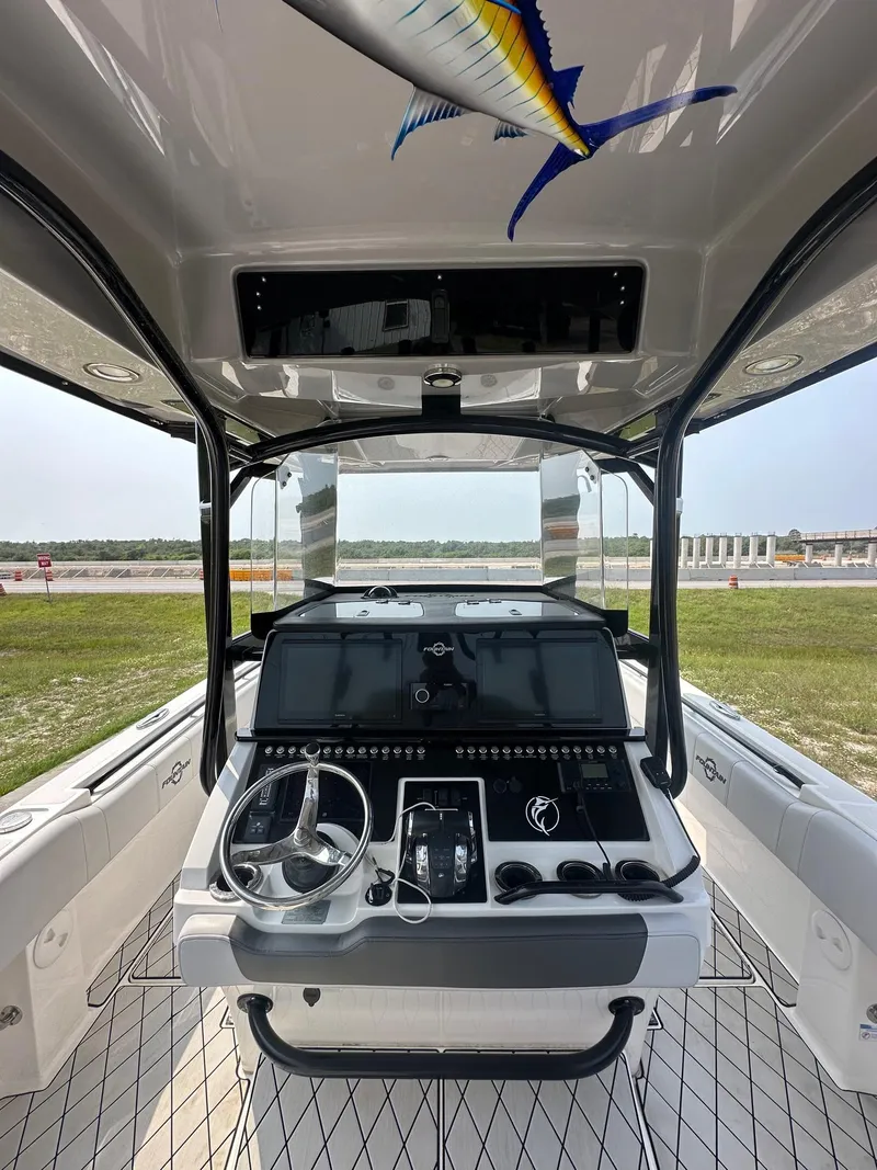 Slide: The Image of 2021 Fountain 34TE boat cockpit with modern controls and marlin graphic. - 5