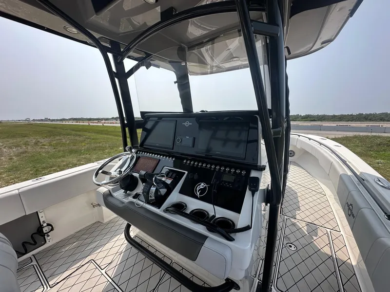 Slide: The Image of 2021 Fountain 34TE boat cockpit with modern controls and steering wheel. - 7