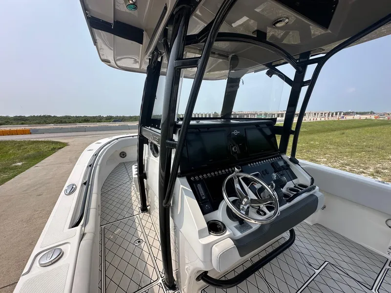 Slide: The Image of 2021 Fountain 34TE boat cockpit with steering wheel and control panel. - 8