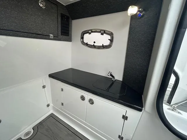 Slide: The Image of 2025 Monterey 27 Elite boat interior with sleek countertop and modern fixtures. - 13