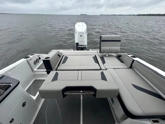 Slide: The Image of 2025 Monterey 27 Elite boat interior with luxurious seating on open water. - 16