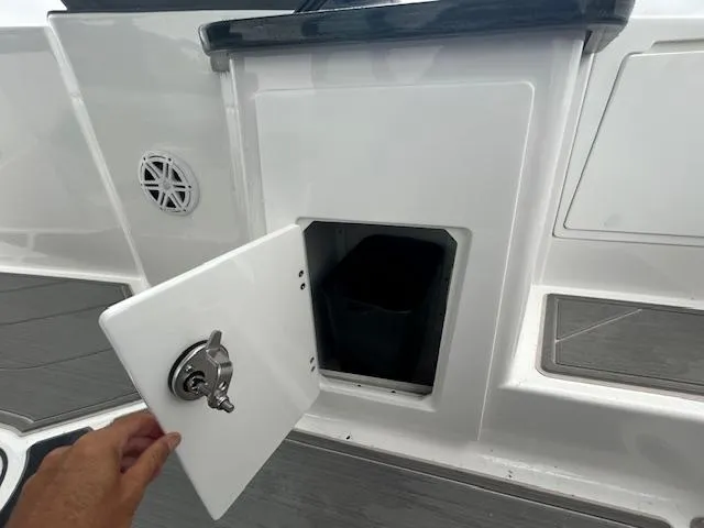 Slide: The Image of 2025 Monterey 27 Elite boat storage compartment with open door. - 17