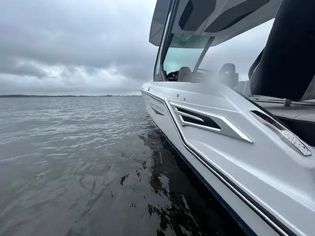 Slide: The Image of 2025 Monterey 27 Elite boat on calm water under cloudy skies. - 19
