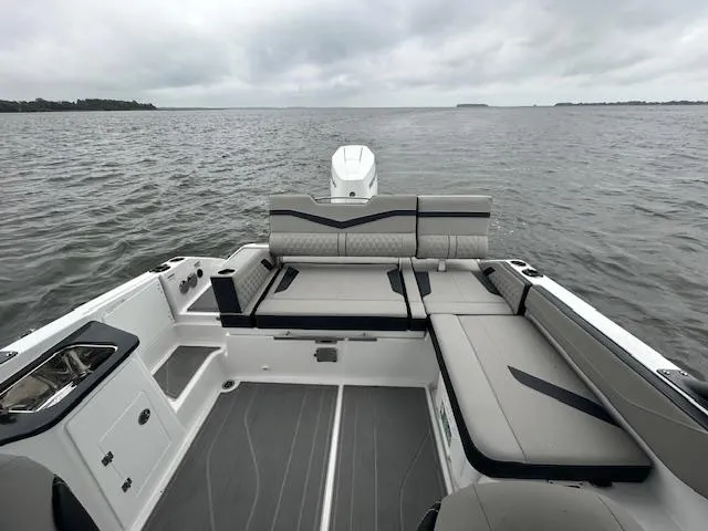 Slide: The Image of 2025 Monterey 27 Elite boat interior with sleek seating on a calm lake. - 21