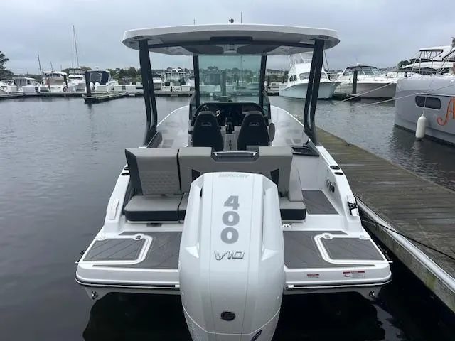 Slide: The Image of 2025 Monterey 27 Elite boat with 400 V10 engine docked at marina. - 3